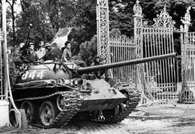 A North Vietnamese tank rolls through the gate of the Presidential Palace in Saigon, signifying the fall of South Vietnam.