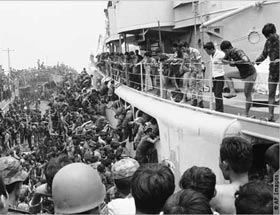 South Vietnamese in Da Nang, Vietnam, after the fall of Saigon in 1975, struggle to climb aboard ships that will evacuate them.